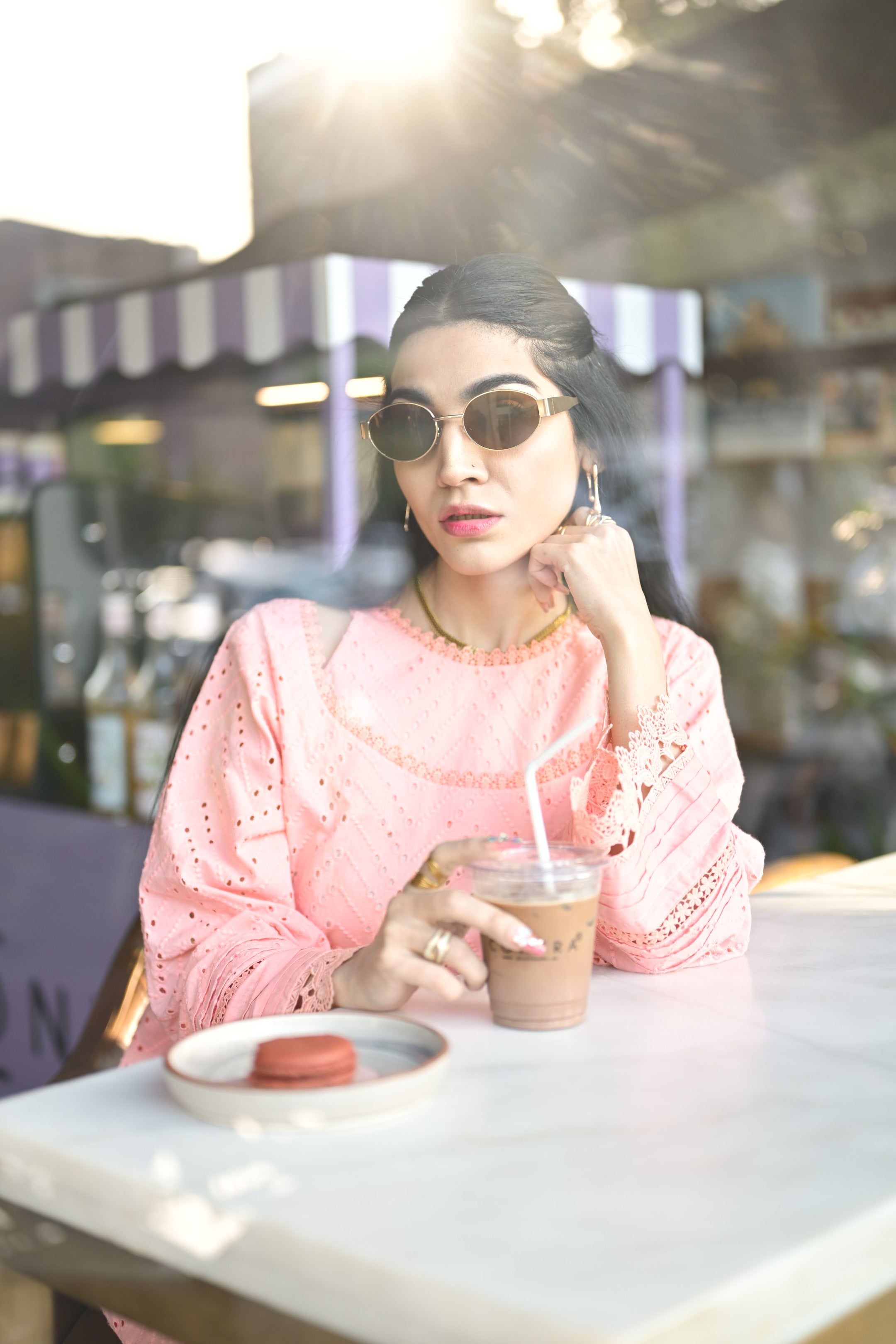Model holding coffee cup wearing Gulaabi Dastaan — showcasing relaxed festive elegance.