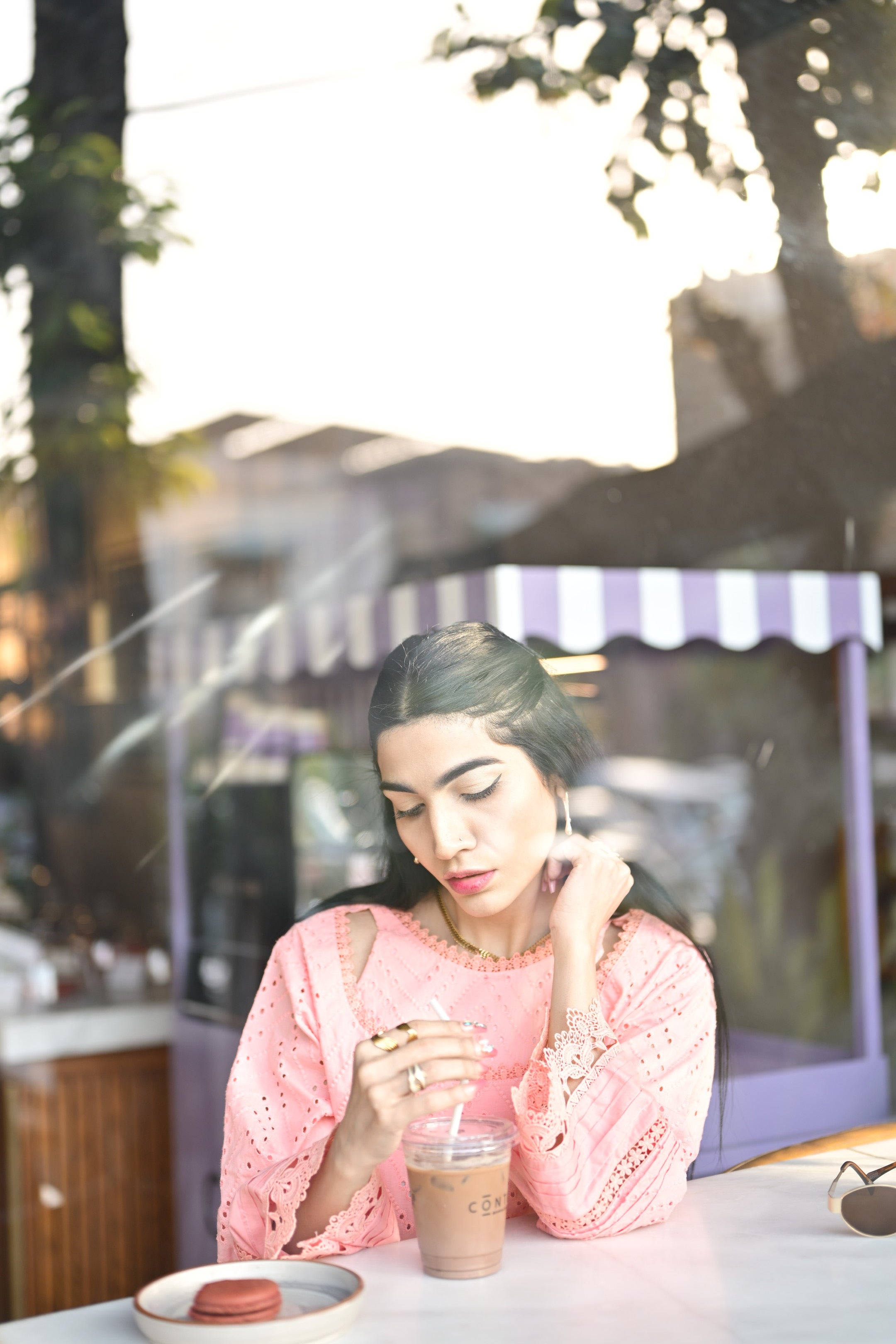 Model smiling in BEBANO’s Gulaabi Dastaan with coffee cup in hand — soft festive vibe.